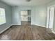 Living room with hardwood floors offering a view of the adjacent kitchen at 1715 S Madison St, Muncie, IN 47302
