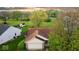 An aerial view of a charming single-story home surrounded by lush greenery and a well-manicured lawn at 2154 Walnut Meadow Ct, Indianapolis, IN 46234