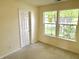 Bright bedroom featuring neutral walls with neutral carpet and large windows overlooking the yard at 2154 Walnut Meadow Ct, Indianapolis, IN 46234