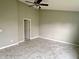 Large bedroom with tile floor, ceiling fan and white door, making for a cozy and inviting space at 2154 Walnut Meadow Ct, Indianapolis, IN 46234