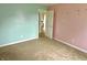 Spacious bedroom featuring two-tone walls with neutral carpet and an entry to another room at 2154 Walnut Meadow Ct, Indianapolis, IN 46234