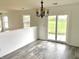 Cozy dining room with modern light fixture and sliding glass doors leading to the backyard at 2154 Walnut Meadow Ct, Indianapolis, IN 46234