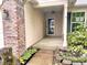 Inviting covered front porch with brick accents and landscaping, perfect for enjoying the outdoors at 2154 Walnut Meadow Ct, Indianapolis, IN 46234
