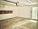 This garage is spacious, with room for parking and storage; the walls are clean and equipped with lighting at 2154 Walnut Meadow Ct, Indianapolis, IN 46234