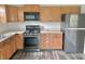 Kitchen showcasing wood cabinets, black stainless steel appliances, and spacious countertops at 2154 Walnut Meadow Ct, Indianapolis, IN 46234
