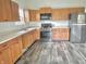 Charming kitchen with wood cabinets, stainless steel appliances, and ample counter space at 2154 Walnut Meadow Ct, Indianapolis, IN 46234