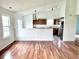 Open floor plan connecting living room with hardwood floors to a functional kitchen at 2154 Walnut Meadow Ct, Indianapolis, IN 46234