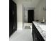 Elegant bathroom featuring black cabinets, marble countertops, and stylish black and white tile floors at 2161 N Pennsylvania N St, Indianapolis, IN 46202