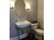 Charming bathroom with pedestal sink, patterned wallpaper, and modern fixtures at 2161 N Pennsylvania N St, Indianapolis, IN 46202