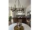 Open-concept dining room featuring a modern chandelier and a view into the living room at 2161 N Pennsylvania N St, Indianapolis, IN 46202