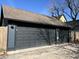 Three-car garage with dark gray doors and siding, offering ample parking and storage at 2161 N Pennsylvania N St, Indianapolis, IN 46202