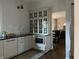 Modern kitchen featuring bright white cabinets, a black countertop, and stainless steel appliances at 2161 N Pennsylvania N St, Indianapolis, IN 46202