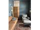 Stylish living room features a leather couch, gray chair, and exposed brick wall at 2161 N Pennsylvania N St, Indianapolis, IN 46202