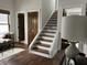 Inviting staircase featuring white trim, hardwood steps, and bright natural lighting at 2161 N Pennsylvania N St, Indianapolis, IN 46202