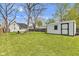 Large backyard featuring a shed and a fire pit area with chairs, ideal for entertaining at 223 Grove St, Greenfield, IN 46140