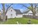 The backyard features a lush lawn, a wooden fence, and the home's exterior, creating a peaceful outdoor space at 223 Grove St, Greenfield, IN 46140