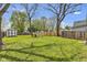 Expansive backyard with lush green grass, mature trees, and outdoor shed at 223 Grove St, Greenfield, IN 46140