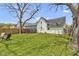 Lush backyard with mature trees, providing a serene outdoor space at 223 Grove St, Greenfield, IN 46140