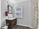 Bathroom featuring wood floors, neutral walls, vanity sink and window at 223 Grove St, Greenfield, IN 46140