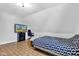 Relaxing bedroom with a TV, gaming chair, and distinctive patterned bedding at 223 Grove St, Greenfield, IN 46140