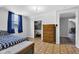 Comfortable bedroom with closet, complemented by a wooden dresser and patterned floors at 223 Grove St, Greenfield, IN 46140
