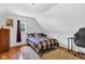 Serene bedroom with plush rug, wood floors, desk and a bright, sunlit window at 223 Grove St, Greenfield, IN 46140