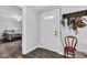 Entryway with coat rack, adjacent to bedroom with wood-look floors at 223 Grove St, Greenfield, IN 46140
