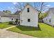 White two-story house with a swing on the front porch and green lawn at 223 Grove St, Greenfield, IN 46140
