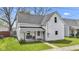 Classic home exterior with a welcoming front porch, swing, and well-manicured lawn at 223 Grove St, Greenfield, IN 46140