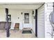 Close-up of the front porch featuring a swing and welcome sign by door at 223 Grove St, Greenfield, IN 46140