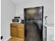 Kitchen includes a black refrigerator and microwave on top of wooden cabinets at 223 Grove St, Greenfield, IN 46140