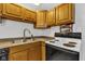 Kitchen area featuring oak cabinets, laminate countertops and white backsplash at 223 Grove St, Greenfield, IN 46140