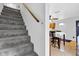 Carpeted stairway with wooden handrail leading to a dining area at 223 Grove St, Greenfield, IN 46140
