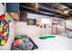 Finished basement game area includes dartboard, basketball game, golf game and comfortable beanbag chairs at 2763 Streamside Dr, Columbus, IN 47203