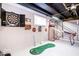 Finished basement area includes golf game, dartboard and a basketball game at 2763 Streamside Dr, Columbus, IN 47203