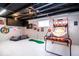 Finished basement features painted ceiling, golf game, beanbags and a basketball game at 2763 Streamside Dr, Columbus, IN 47203