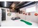 Finished basement area includes speckled floor, exposed ceiling and fun entertainment and games at 2763 Streamside Dr, Columbus, IN 47203