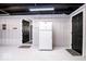 Basement level with speckled floor and black doors along the light colored walls at 2763 Streamside Dr, Columbus, IN 47203