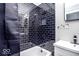 Updated bathroom featuring a tiled shower/bath, modern vanity, and black accents for a stylish look at 2763 Streamside Dr, Columbus, IN 47203