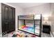 Bright bedroom features a bunk bed, unique carpet, and fresh, neutral walls at 2763 Streamside Dr, Columbus, IN 47203