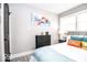 Well-lit bedroom featuring a large dresser, nightstand, and colorful wall art at 2763 Streamside Dr, Columbus, IN 47203