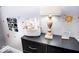 Bright bedroom features a black dresser with lamp, decor, and books at 2763 Streamside Dr, Columbus, IN 47203