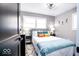 Modern bedroom with a plush bed, bright throw pillows, and black nightstands at 2763 Streamside Dr, Columbus, IN 47203
