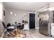 Bright dining area featuring a table with black chairs and a coffee bar, adjacent to a stainless steel refrigerator at 2763 Streamside Dr, Columbus, IN 47203