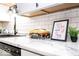 Kitchen counter featuring decorative elements like a movie-themed snack box and an inspirational sign, and white subway tiles at 2763 Streamside Dr, Columbus, IN 47203