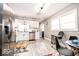 Bright kitchen with stainless steel appliances, white cabinetry, and a view of the dining area and a door at 2763 Streamside Dr, Columbus, IN 47203
