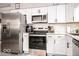 Modern kitchen featuring stainless steel appliances, white cabinetry, and a subway tile backsplash at 2763 Streamside Dr, Columbus, IN 47203