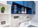 Clean laundry room with new machines, blue cabinets, and unique decorative touches at 2763 Streamside Dr, Columbus, IN 47203