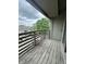 A balcony featuring a wooden railing and deck with a small stool, with an exterior view at 2967 Eagles Crest Cir # C, Indianapolis, IN 46214