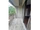 Balcony featuring a weathered wooden deck, railing, and sliding glass door, with tree view at 2967 Eagles Crest Cir # C, Indianapolis, IN 46214